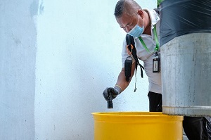 Checking a litter bin for mosquito breeding - 2